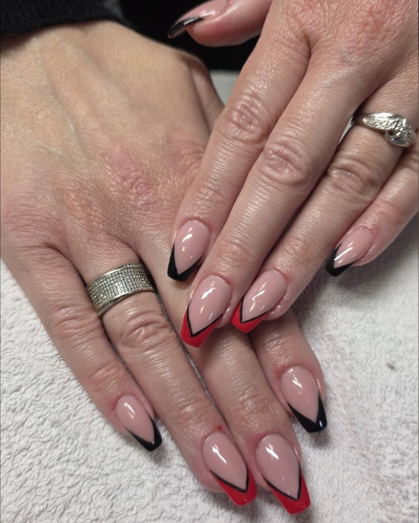 Almond nails with sharp V shaped tips, alternating between red and black